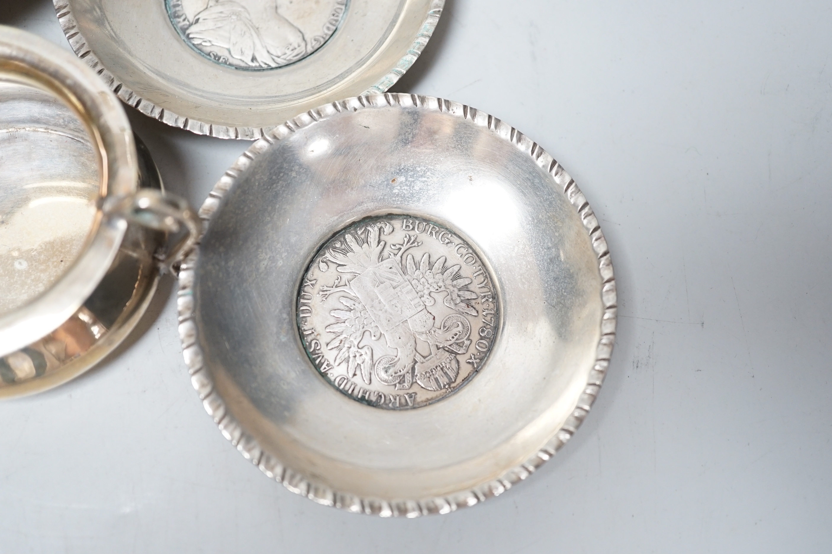 A modern pair of small silver mounted coasters, diameter 79mm, seven other silver or white metal dishes including Dutch and a small silver cream jug.